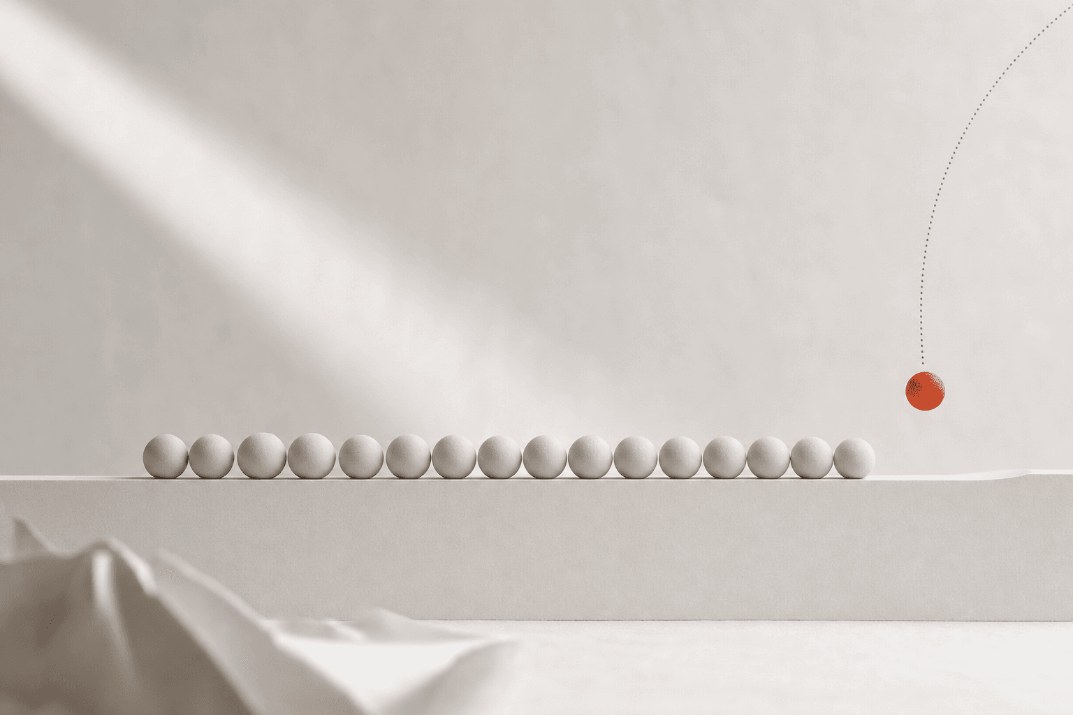 A long row of small pale spheres rests evenly spaced along a paper-white ledge while one burnt-orange sphere descends toward the empty next place on a fine dotted arc: the quiet cadence of one lead arriving every day.