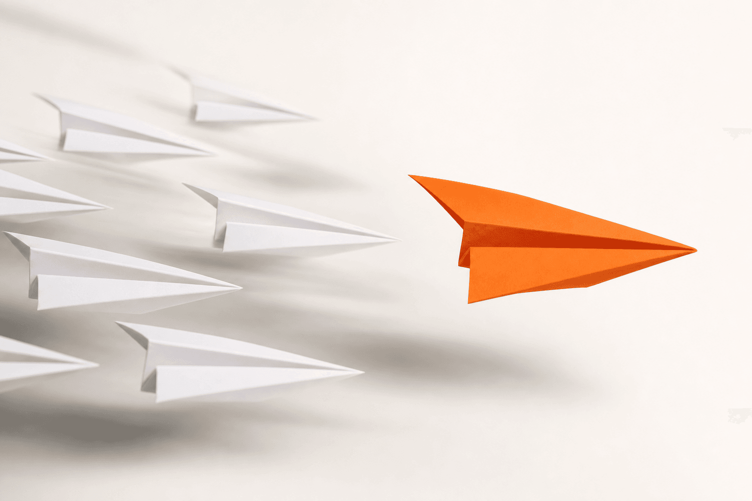 One orange paper plane flying out ahead of a pack of white paper planes: the first reply that wins the race.